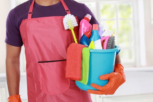 Cleaning professional with protective equipment in a home setting