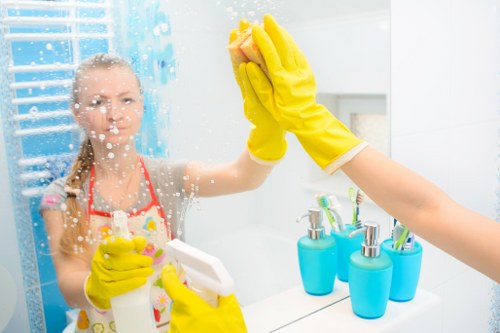 Cleaner reporting an incident and making the work area safe after a spill